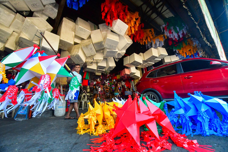 A worker arranges lanterns on sale in a market in Quezon City on Sunday. Mark Demayo, ABS-CBN News