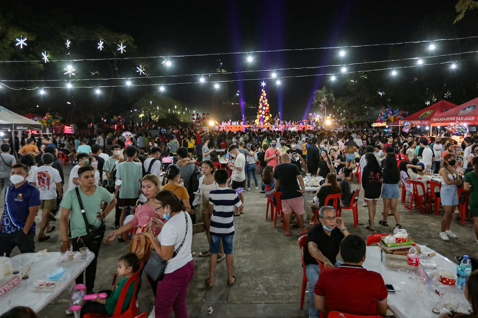  Locals attend the lighting of a Christmas tree at the Pinaglabanan Shrine in San Juan City on Dec. 2, 2022. George Calvelo, ABS-CBN News