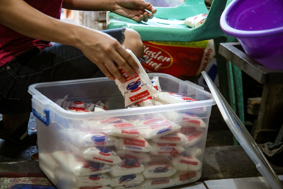 A vendor arranges her stock of sugar at a store in Barangka St., in Mandaluyong City on August 29, 2022. Jonathan L. Cellona, ABS-CBN News