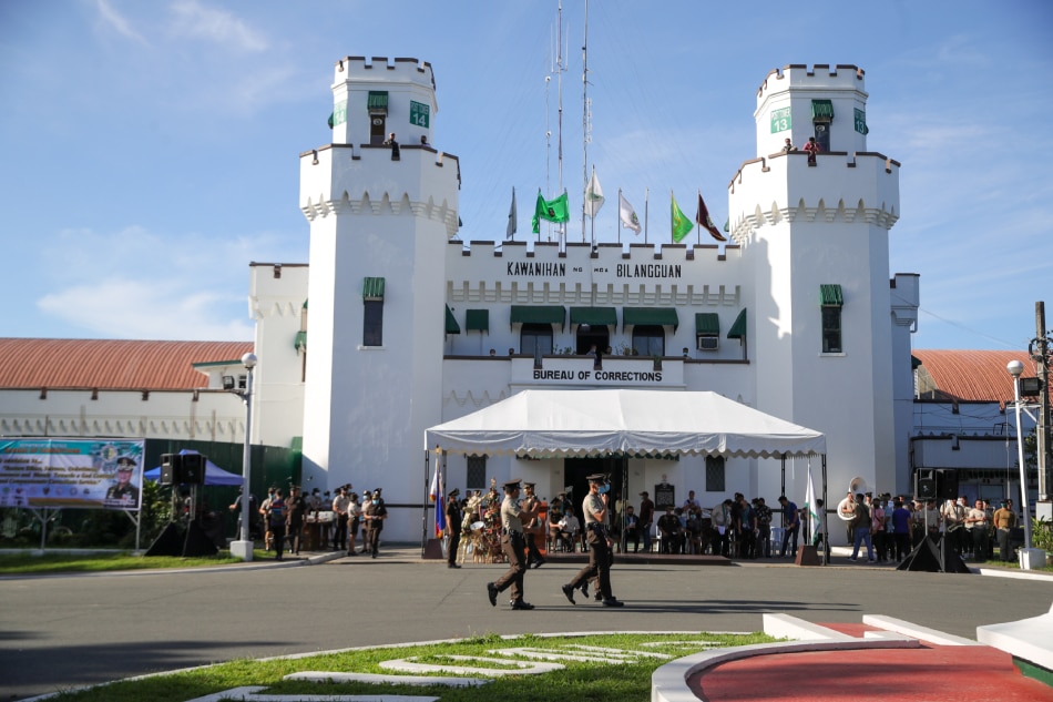 Officers and staff of New Bilibid Prison in Muntinlupa City stand at attention during the flag ceremony as they hold their 117th Founding Anniversary on November 14, 2022. Jonathan Cellona, ABS-CBN News/File