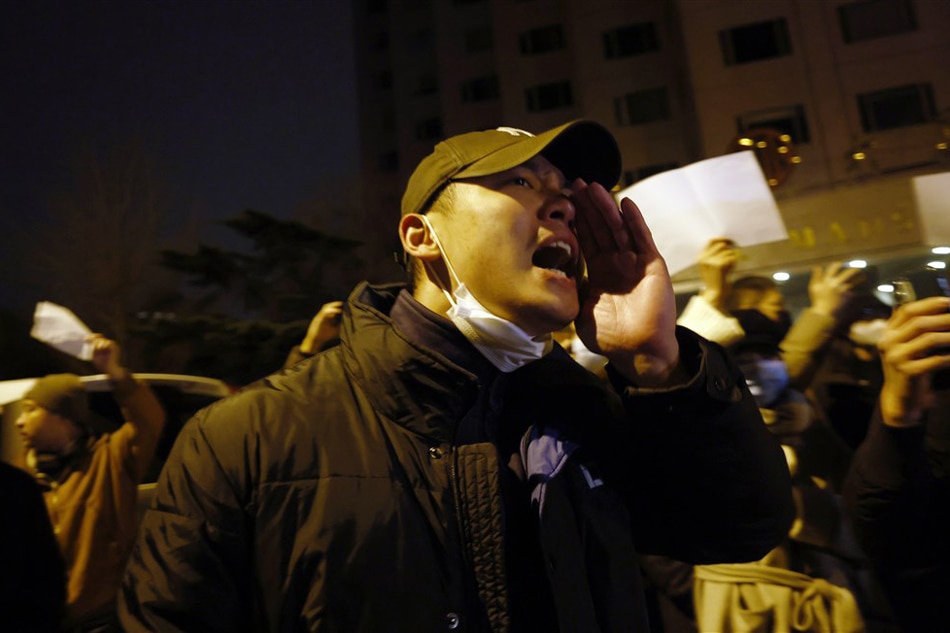 Protesters shout while holding blank white pieces of paper during a protest triggered by a fire in Urumqi, that killed 10 people, in Beijing, China on November 27, 2022. Mark Cristino, EPA-EFE/File