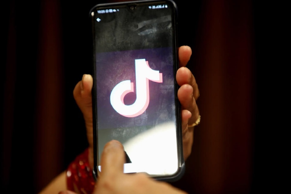 A woman opens the Chinese video-sharing app TikTok on her smartphone, in Bhopal, central India, 29 June 2020. Sanjeev Gupta, EPA-EFE/file