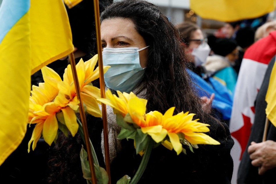 People demonstrate against Russian invasion of Ukraine, in Toronto A woman holds sunflowers as she takes part in an anti-war protest, after Russia launched a massive military operation against Ukraine, in Toronto, Ontario, Canada, February 27, 2022. Chris Helgren, Reuters