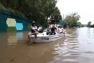 Australians flee floods as toll rises to 12