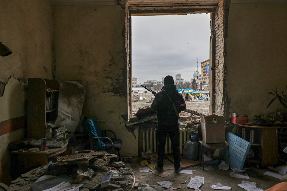 A member of the Territorial Defense Forces of Ukraine stands inside the damaged Kharkiv regional administration building in the aftermath of a shelling in downtown Kharkiv, Ukraine, March 1, 2022. Russian troops entered Ukraine on Feb. 24, prompting the country's president to declare martial law and triggering a series of announcements by Western countries to impose severe economic sanctions on Russia. Sergey Kozlov, EPA-EFE