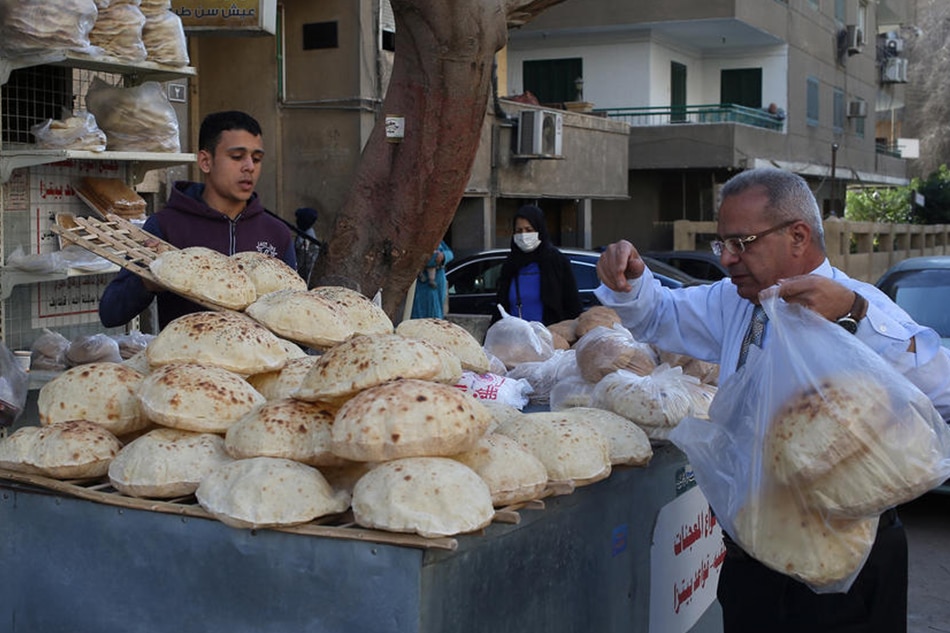 An Egyptian man buys bread from a bakery in Cairo, Egypt, 03 March 2022. The Russian aggression on Ukraine has affected the price of wheat worldwide, as the two countries control 29 percent of the global wheat trade. Khaled Elfiqi, EPA-EFE 