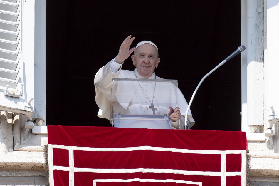A handout picture provided by the Vatican Media shows Pope Francis leading the Angelus prayer from the window of his office overlooking Saint Peter