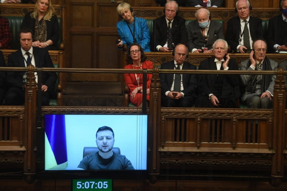 A handout photograph released by the UK Parliament shows Ukrainian President Volodymyr Zelensky (onscreen) addressing via video-link the House of Commons Chamber in London on March 8, 2022 about the situation in Ukraine. Jessica Taylor, UK Parliament handout/EPA-EFE