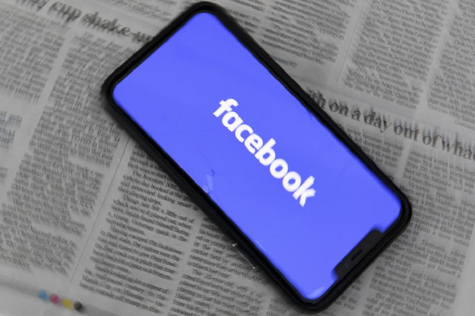 An illustration image shows a phone screen with the Facebook logo and Australian Newspapers at Parliament House in Canberra, Australia, 18 February 2021. Lukas Coch, Australia and New Zealand Out/EPA-EFE