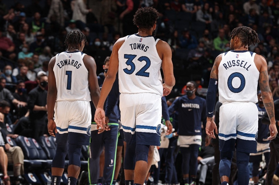 Anthony Edwards #1, Karl-Anthony Towns #32 and D'Angelo Russell #0 of the Minnesota Timberwolves walk off the court against the New Orleans Pelicans on October 25, 2021 at Target Center in Minneapolis, Minnesota. File photo. David Sherman/NBAE via Getty Images/AFP