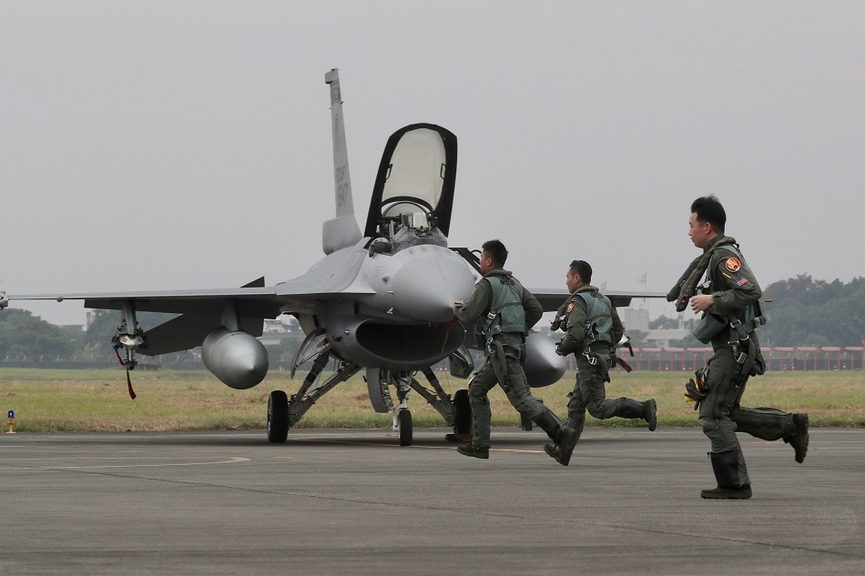 Taiwan Air Force pilots run toward F-16V fighter jets during a military drill inside the airbase during a military drill in Chiayi, Taiwan, on January 5, 2022. Ritchie B. Tongo, EPA-EFE/File