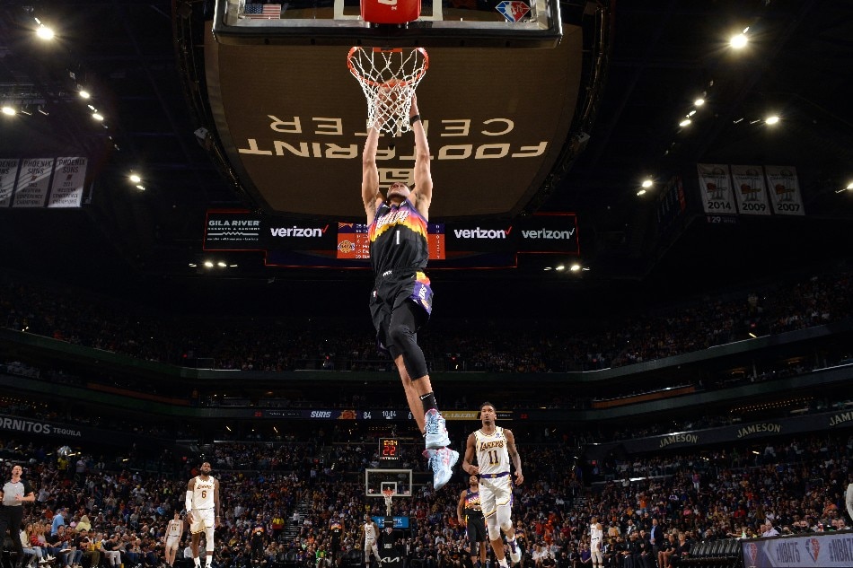 Devin Booker #1 of the Phoenix Suns dunks the ball during the game against the Los Angeles Lakers on March 13, 2022 at Footprint Center in Phoenix, Arizona. Barry Gossage, NBAE via Getty Images/AFP