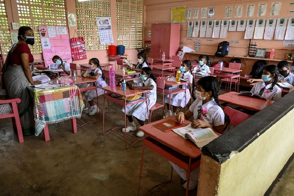 School girls attend class at a Buddhist school in Colombo on October 21, 2021, as schools with less than 200 students reopened for the first time since March 2020 after the government eased coronavirus restrictions. Ishara Kodikara, AFP/ File