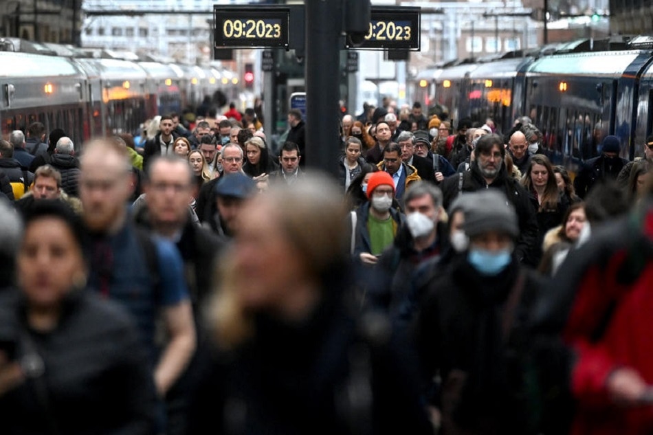Travelers arrive at Kings Cross station in London, February 24, 2022. All remaining legal COVID restrictions have been removed in England. People are no longer legally required to self-isolate if they test positive for COVID. The changes are part of the government's 