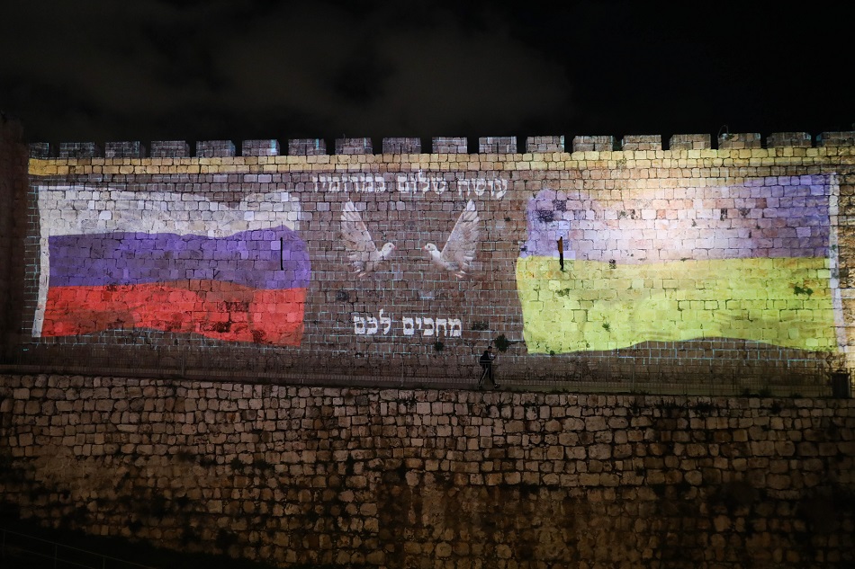 The Ukrainian flag (R) and the Russian flag (L) is projected on the walls of the Old City of Jerusalem. Abir Sultan, EPA-EFE