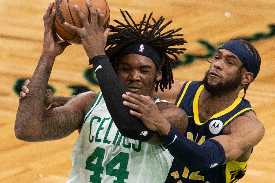 Boston Celtics center Robert Williams III (L) is fouled by Indiana Pacers forward Oshae Brissett (R) during the first quarter at the TD Garden in Boston, Massachusetts, USA, 10 January 2022. File photo. CJ Gunther, EPA-EFE