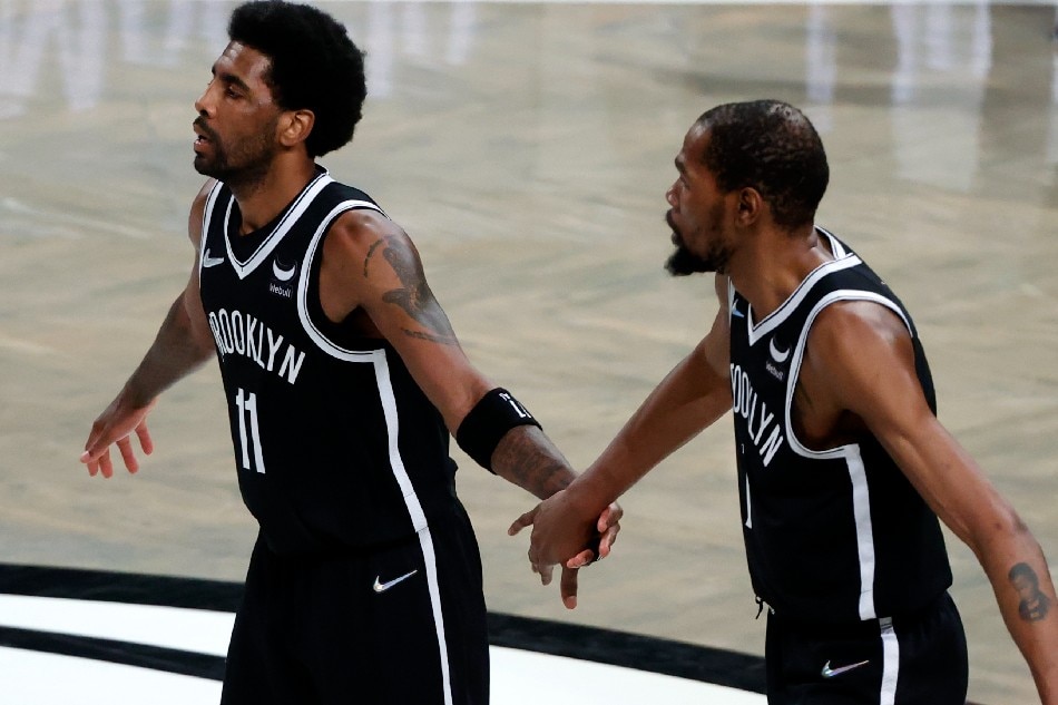 Brooklyn Nets guard Kyrie Irving (L) high-fives teammate Kevin Durant (R) during the first half of the NBA game between the Detroit Pistons and the Brooklyn Nets at the Barclays Center in Brooklyn, New York, USA, 29 March 2022. Jason Szenes, EPA-EFE