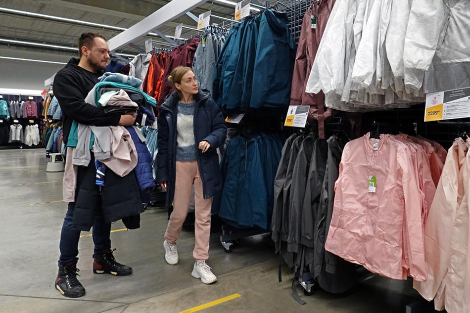 People do shopping at a French sports retailer Decathlon store in Moscow, Russia, 30 March 2022. Sportswear retailer Decathlon in a statement on 29 March announced suspension of its operation in Russia following criticism and calls for boycott of the brand on social media worldwide. Maxim Shipenkov, EPA-EFE/File