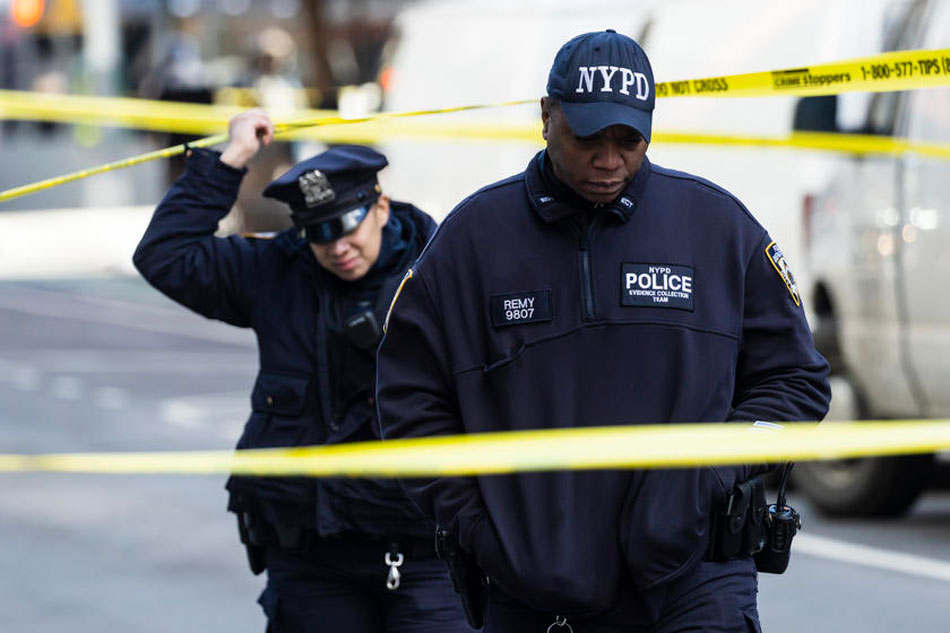 New York City police officers investigate the scene of a shooting in the midtown neighborhood of New York, New York, USA, Feb. 10, 2022. Justin Lane, EPA-EFE/File 