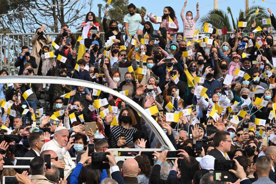 Pope Francis arrives in the popemobile to celebrate mass outside the St. Publius Parish Church at Piazzale dei Granai in Floriana, Valletta, Malta on Sunday. Pope Francis made his first international visit this 2022 to the Mediterranean archipelago focusing on themes of evangelization and the need to welcome, protect and integrate migrants and refugees. Andreas Solaro, AFP