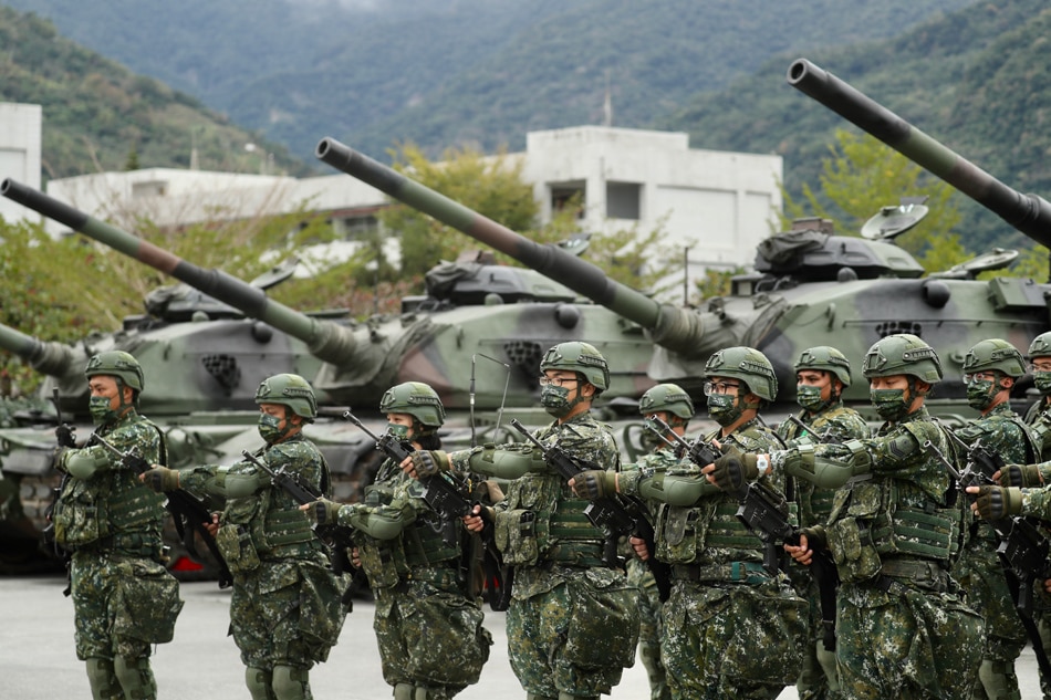 Taiwanese military personnel hold rifles during the visit of Taiwan President Tsai Ing-wen (not pictured) at a military base in Taitung, Taiwan, January 21, 2022. President Tsai Ing-wen pledged to strengthen Taiwan’s defense capabilities amidst the rising military tension between China and Taiwan. EPA-EFE/Ritchie B. Tongo