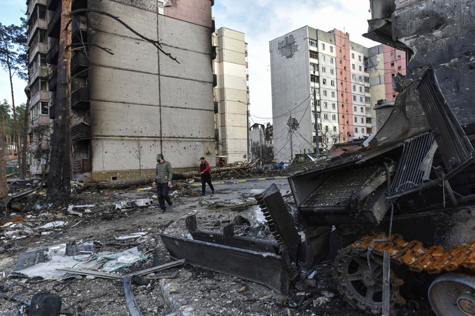 People look on at destroyed apartment blocks in Irpin city, which was the recaptured by the Ukrainian army, Kyiv area, Ukraine, April 7, 2022. Oleg Petrasyuk, EPA-EFE