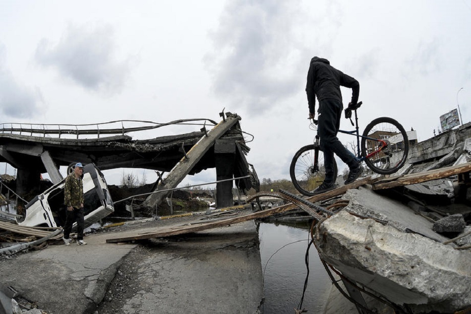 A local man with a bicycle crosses the damaged bridge outside the recaptured city of Irpin, Ukraine, 10 April 2022. Russian troops entered Ukraine on 24 February resulting in fighting and destruction in the country and triggering a series of severe economic sanctions on Russia by Western countries. Andrii Nesterenko, EPA-EFE 