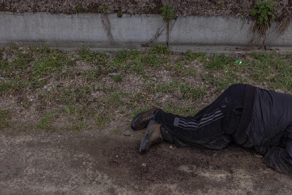 The body of a dead civilian lies on the ground, in Bucha, northwest of Kyiv, Ukraine, on April 6, 2022. Hundreds of tortured and killed civilians have been found in Bucha and other parts of the Kyiv region after the Russian army retreated from those areas. Roman Pilipey, EPA-EFE