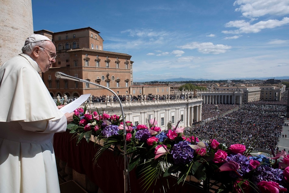 This photo taken and handout on April 17, 2022 by The Vatican Media shows Pope Francis deliver the Easter 'Urbi et Orbi' message from the balcony of St. Peter's Basilica overlooking St. Peter's square in The Vatican