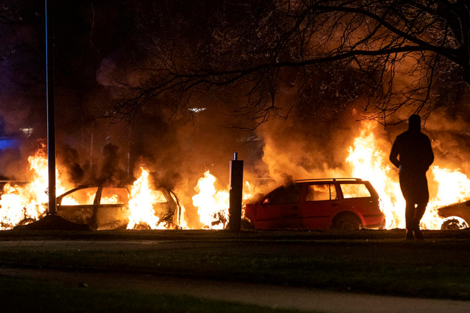 Cars burn during a protest at Rosengard in Malmo, Sweden, on April 17, 2022. Johan Nilsson, EPA-EFE