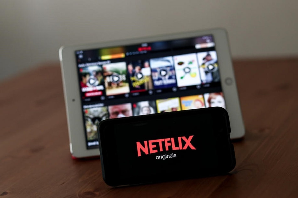 A Netflix page and logo displayed on a tablet and smartphone in Istanbul, Turkey, August 2, 2019. Sedat Suna, EPA-EFE/file