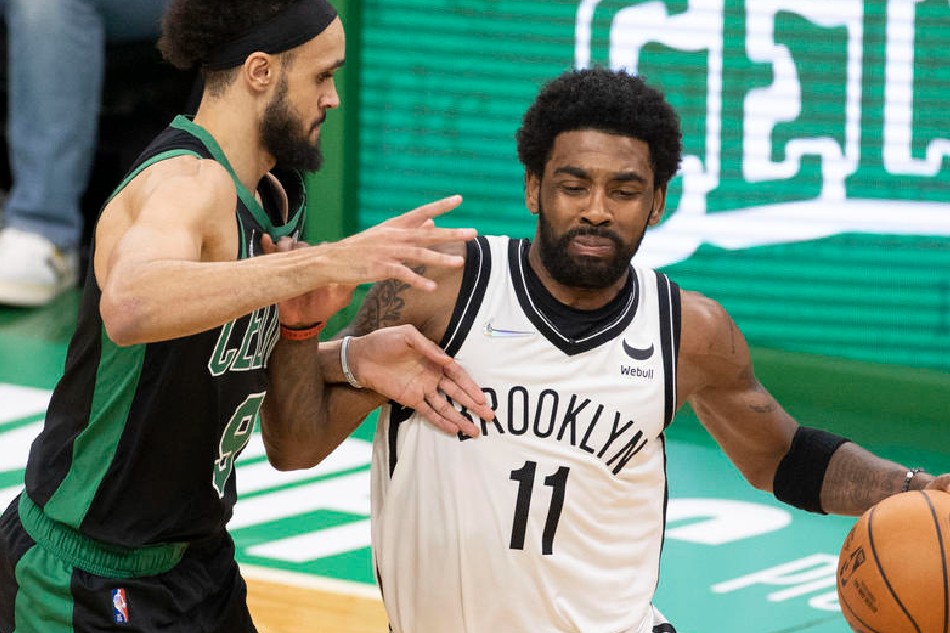 Nets guard Kyrie Irving drives to the basket around Celtics guard Derrick White in Game 1 of their NBA Playoffs series on April 17, 2022. CJ Gunther Shutterstock out, EPA-EFE/file