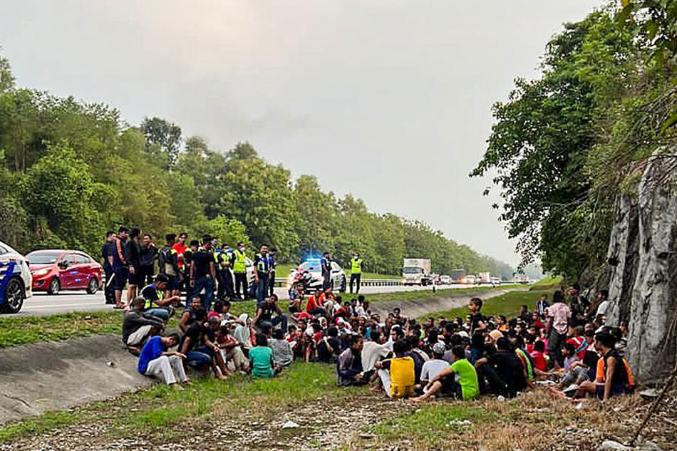 A handout photo made available by the Malaysia Royal Police shows police detaining Rohingya refugees who had escaped from the Sungai Bakap Temporary Immigration Depot in Penang, Malaysia, April 20, 2022. EPA-EFE/Malaysia Royal Police