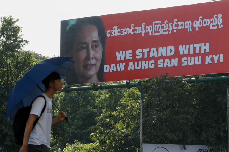 A man walks near a billboard with the portrait of Myanmar State Counsellor Aung San Suu Kyi in Yangon, Myanmar, on December 5, 2019. Lynn Bo bo/EPA-EFE