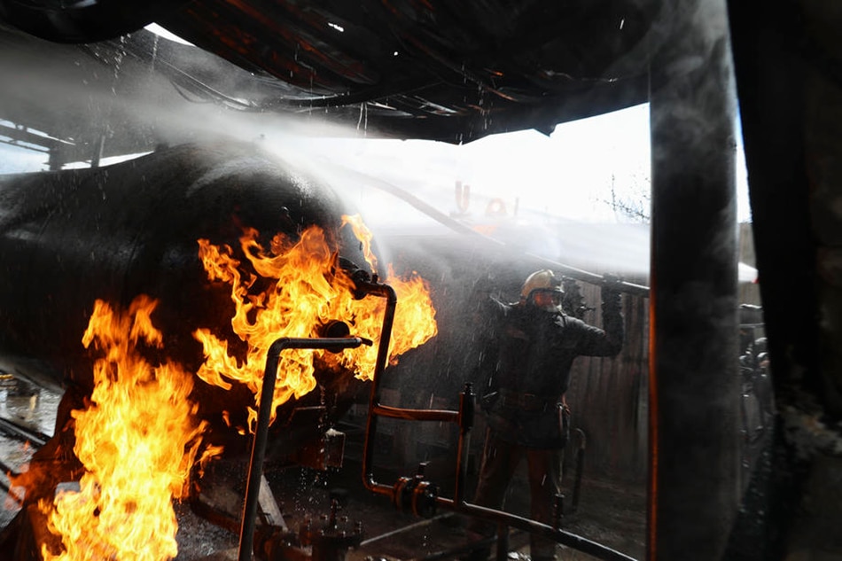 Firemen put out a fire at a gas station in the Eastern Ukrainian city of Kharkiv on April 27, 2022. The city of Kharkiv, Ukraine's second-largest, has witnessed repeated airstrikes from Russian forces. Sergey Kozlov, EPA-EFE