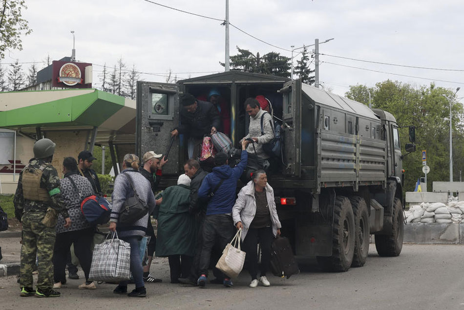Local people exit a truck on a road as they are evacuating from Ruska Lozova village near Kharkiv, Ukraine on April 29, 2022. Sergey Kozlov, EPA-EFE