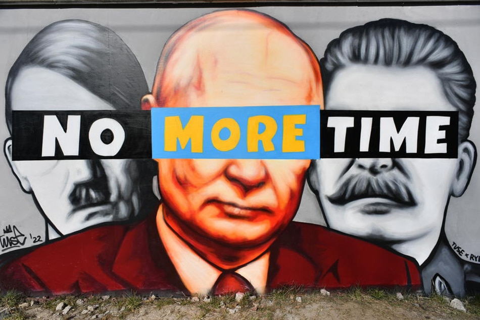 A mural showing Hitler, Putin and Stalin 'No more time' created by graffiti artist Tuse, is sprayed on a wall n Gdansk, northern Poland, on March 22, 2022. Adam Warzawa, EPA-EFE/file