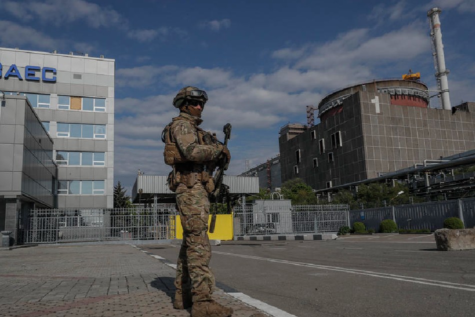A picture taken during a visit to Mariupol organized by the Russian military shows Russian serviceman on guard in front of the Zaporizhzhia Nuclear Power Station in Enerhodar, southeastern Ukraine, on May 1, 2022. Sergei Ilnitsky, EPA-EFE