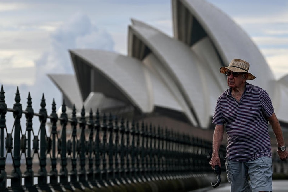 A person walks near the Sydney Opera House in Sydney, Australia, 23 February 2022. Bianca de Marchi, EPA-EFE 