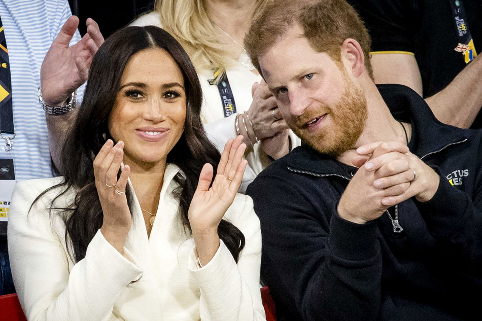 Britain's Prince Harry, Duke of Sussex (R) and his wife, Meghan, Duchess of Sussex (L) attend the sitting volleyball section of the fifth edition of the Invictus Games in The Netherlands in this April 17, 2022 file photo. Sem Van der Wal, EPA-EFE