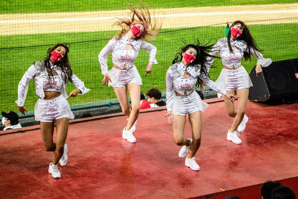 In this picture taken on April 20, 2022, professional cheerleaders for South Korean baseball team SSG Landers (L-R) Bae Soo-hyun, 37, South Korea's longest-serving cheerleader, Park Hyun-yeong, 22, Mok Na-gyeong, 21, and Kim Doa, 27, perform at the Incheon SSG Landers Field in Incheon. Anthony Wallace, AFP