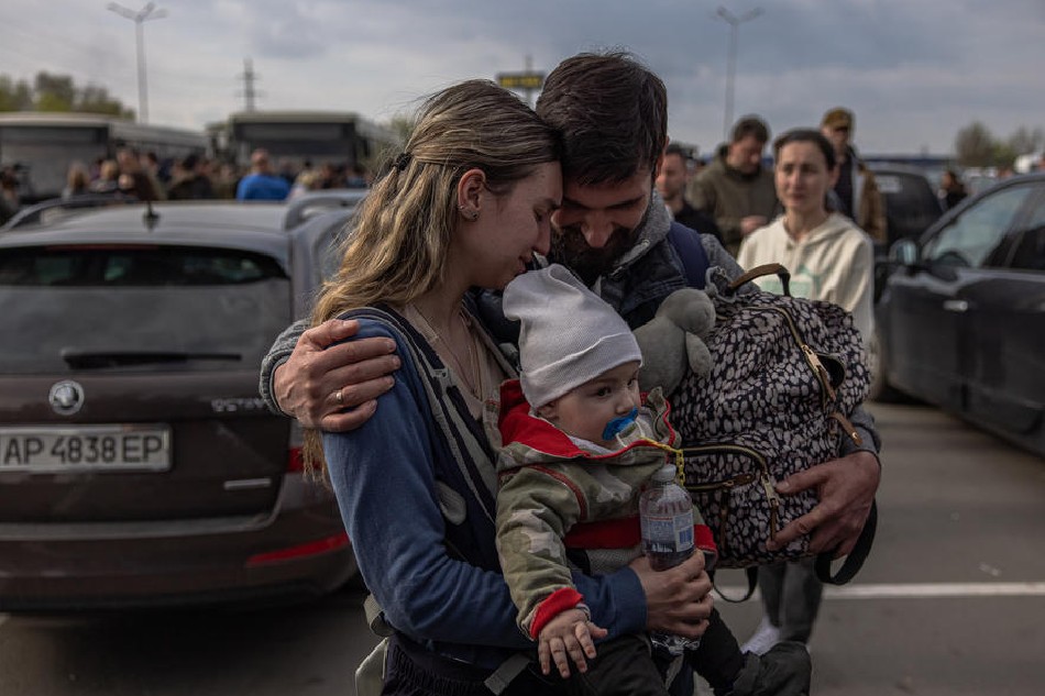 A man welcomes Anna and her son Svyatoslav who were evacuated from Mariupol at the evacuation point in Zaporizhzhia, Ukraine, May 3, 2022. Around 100 civilians were evacuated from the steel plant, the last Ukrainian-controlled area in the southern port city of Mariupol, according to Ukrainian officials. Thousands of people who were still in Mariupol and other areas in South Ukraine occupied by the Russian army waited to be evacuated to Ukraine's controlled area by buses and their own cars. Roman Pilipey, EPA-EFE
