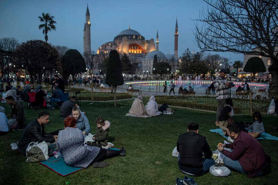 People break their fast on the first day of Ramadan in front of the Hagia Sophia Grand Mosque in Istanbul, Turkey, 02 April 2022. Erdem Sahin, EPA-EFE