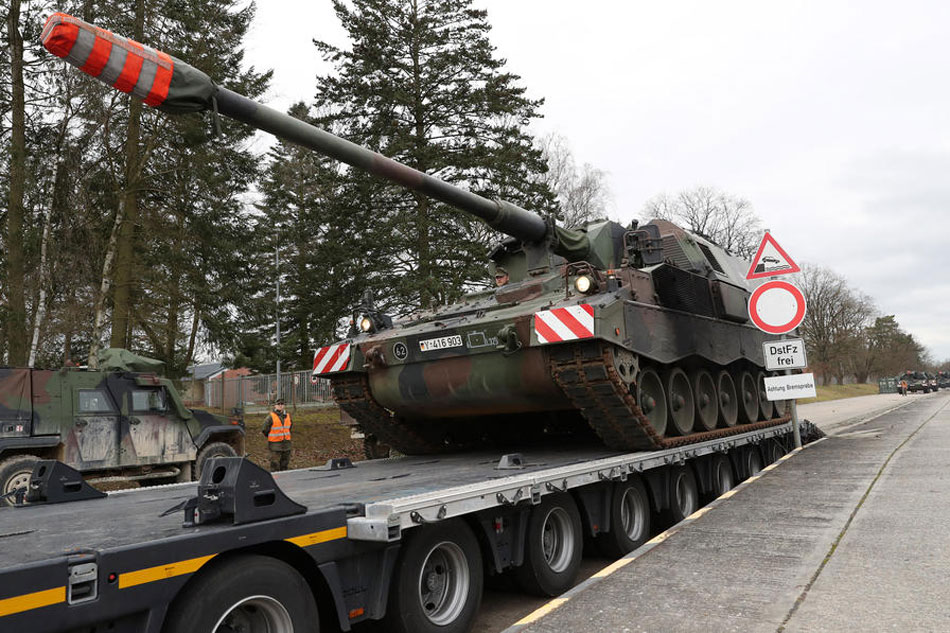 A self-propelled howitzer type Panzerhaubitze PzH 2000 of the German Army is loaded onto a truck at the Hindenburg barracks in Munster, northern Germany, on February 14, 2022. Focke Strangmann, EPA-EFE/file