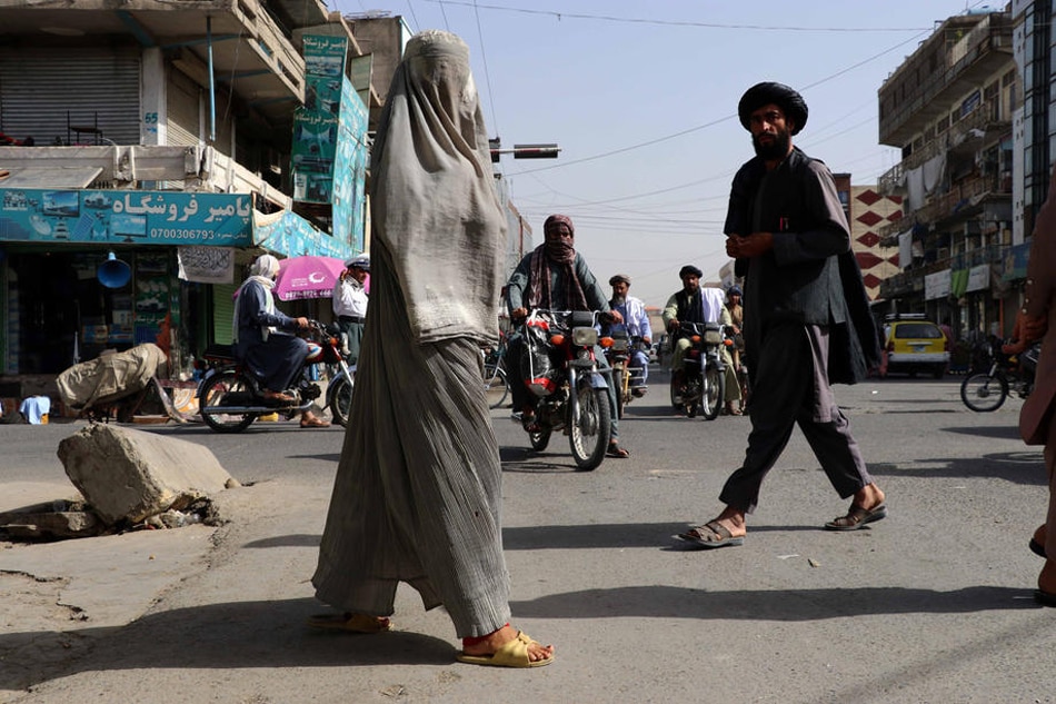 Women walk on a road in Kandahar, Afghanistan, on May 8, 2022. EPA-EFE/Stringer