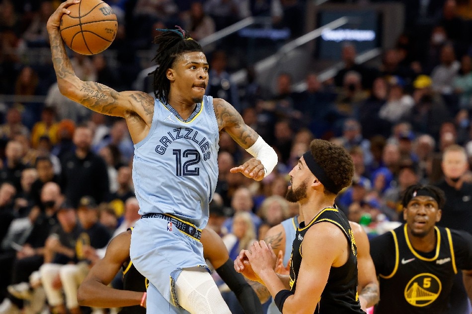 Memphis Grizzlies guard Ja Morant (L) goes to the basket for two points over Golden State Warriors guard Klay Thompson (C) during the second half of Game 3 of their NBA Western Conference semifinal playoff series at the Chase Center, in San Francisco, California, USA, 07 May 2022. John Mabanglo, EPA-EFE