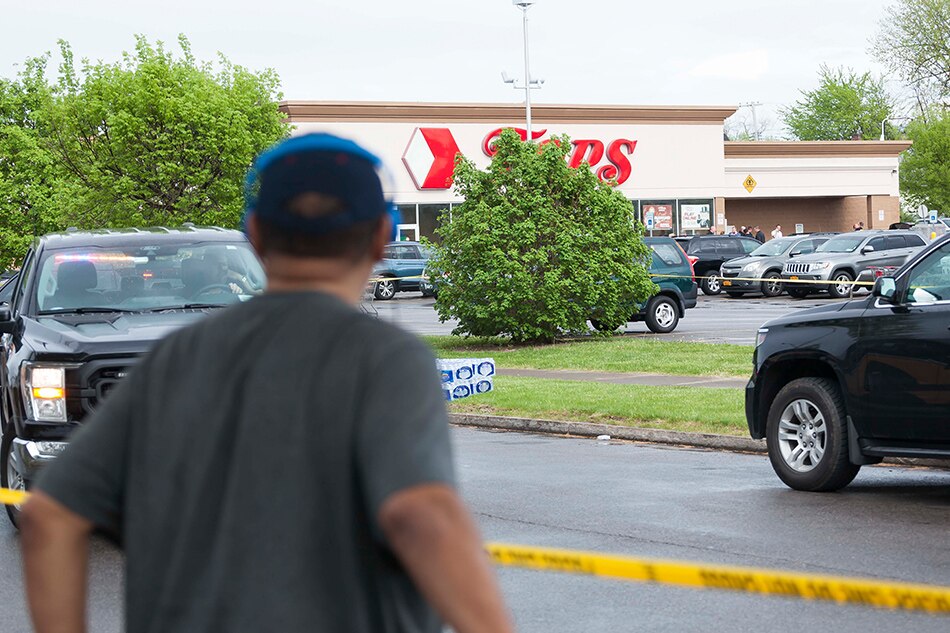 A man standing in front of police tape looks at the scene of a mass shooting at the Tops Friendly Market grocery store in Buffalo, New York, USA, 14 May 2022. A gunman, who has been taken into custody by police, reportedly opened fire at the market killing as many as 10 people. Brandon Watson, EPA-EFE