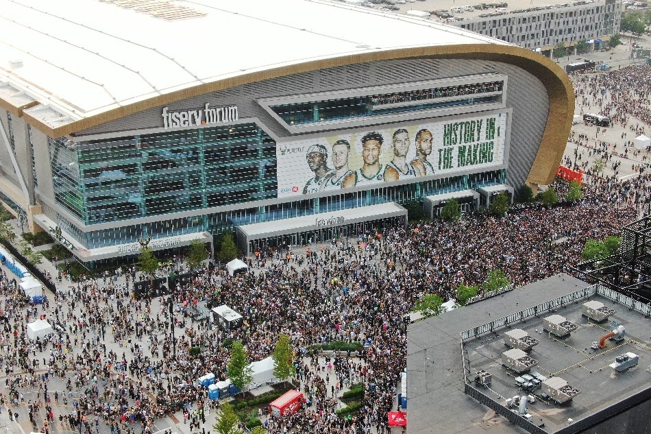 A photograph made with a drone shows thousands of fans filling into the 'Deer District' outside Fiserv Forum before the start of Game 6 of the NBA Finals between the Phoenix Suns and the Milwaukee Bucks at Fiserv Forum in Milwaukee, Wisconsin, USA, 20 July 2021. File photo. Tannen Maury, EPA-EFE