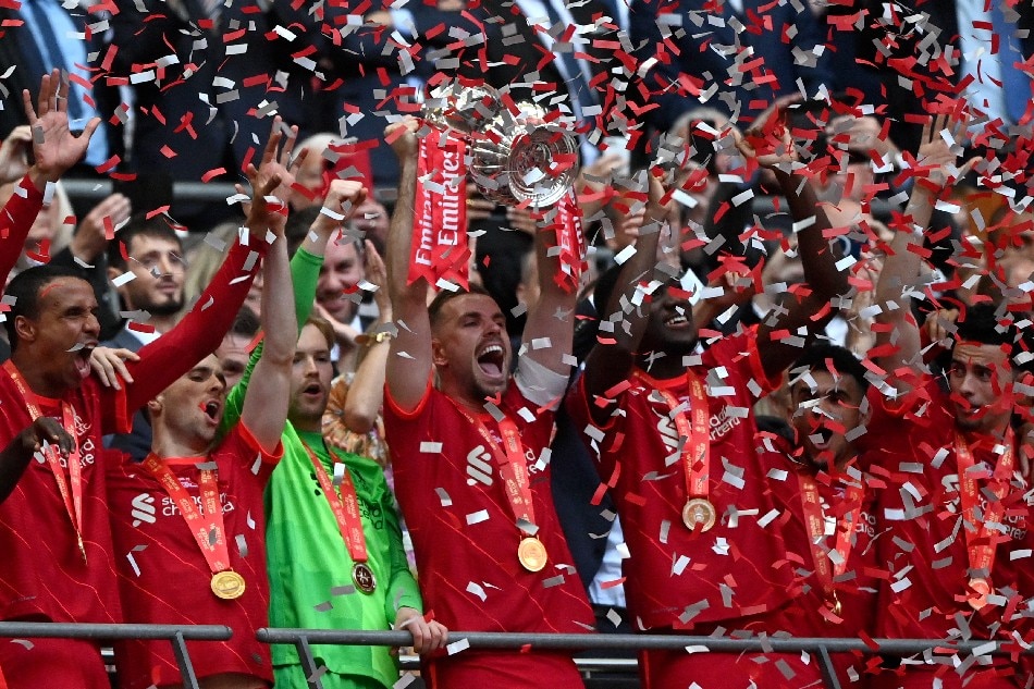 Liverpool's Jordan Henderson (C) lifts the trophy as Liverpool players celebrate after winning the English FA Cup final between Chelsea FC and Liverpool FC at Wembley in London, Britain, 14 May 2022. Neil Hall, EPA-EFE.