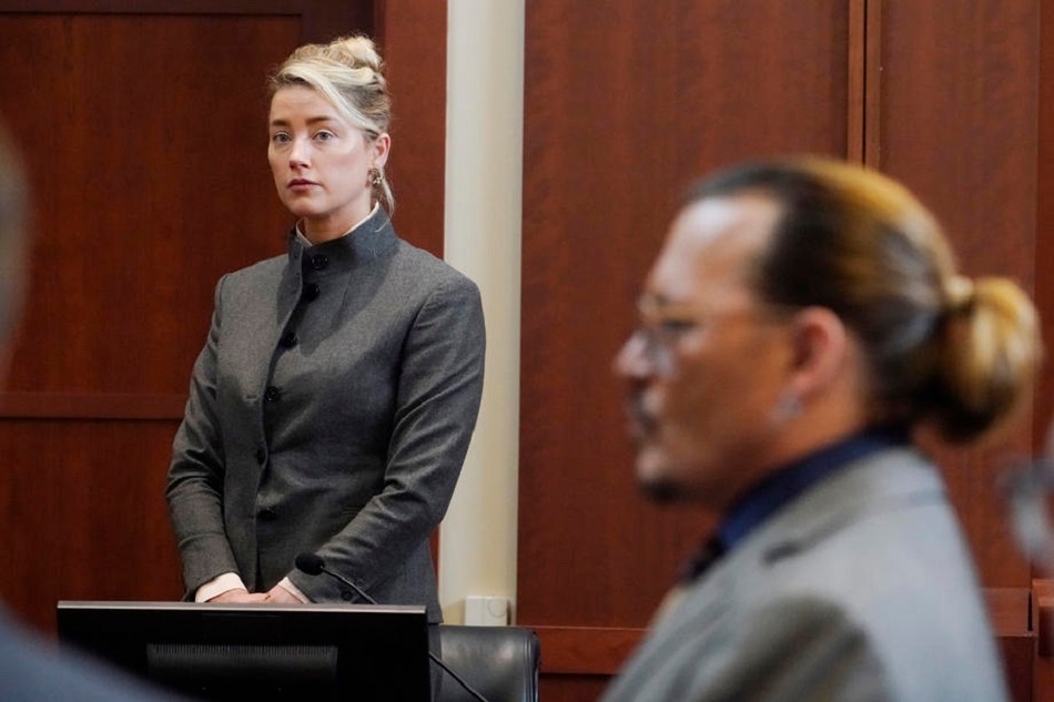 Actress Amber Heard and Actor Johnny Depp watch as the jury leave the courtroom for a lunch break at the Fairfax County Circuit Courthouse in Fairfax, Virginia, USA, May 16, 2022. Johnny Depp's $50 million defamation lawsuit against Amber Heard that started on 10 April is expected to last five or six weeks. Steve Helber/EPA-EFE/Pool